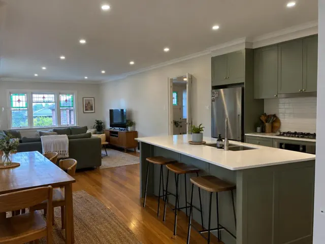 Open-plan home interior with recessed LED downlights in a kitchen and living area in Merewether