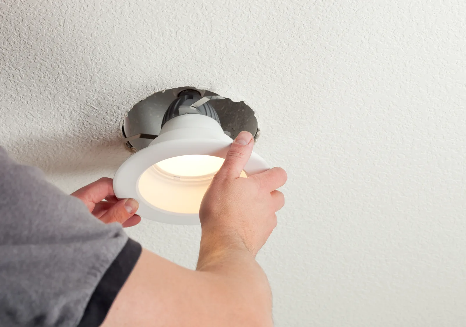 Recessed ceiling light being fitted