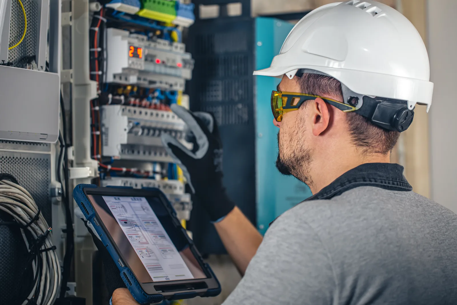 Licensed electrician inspecting a distribution board