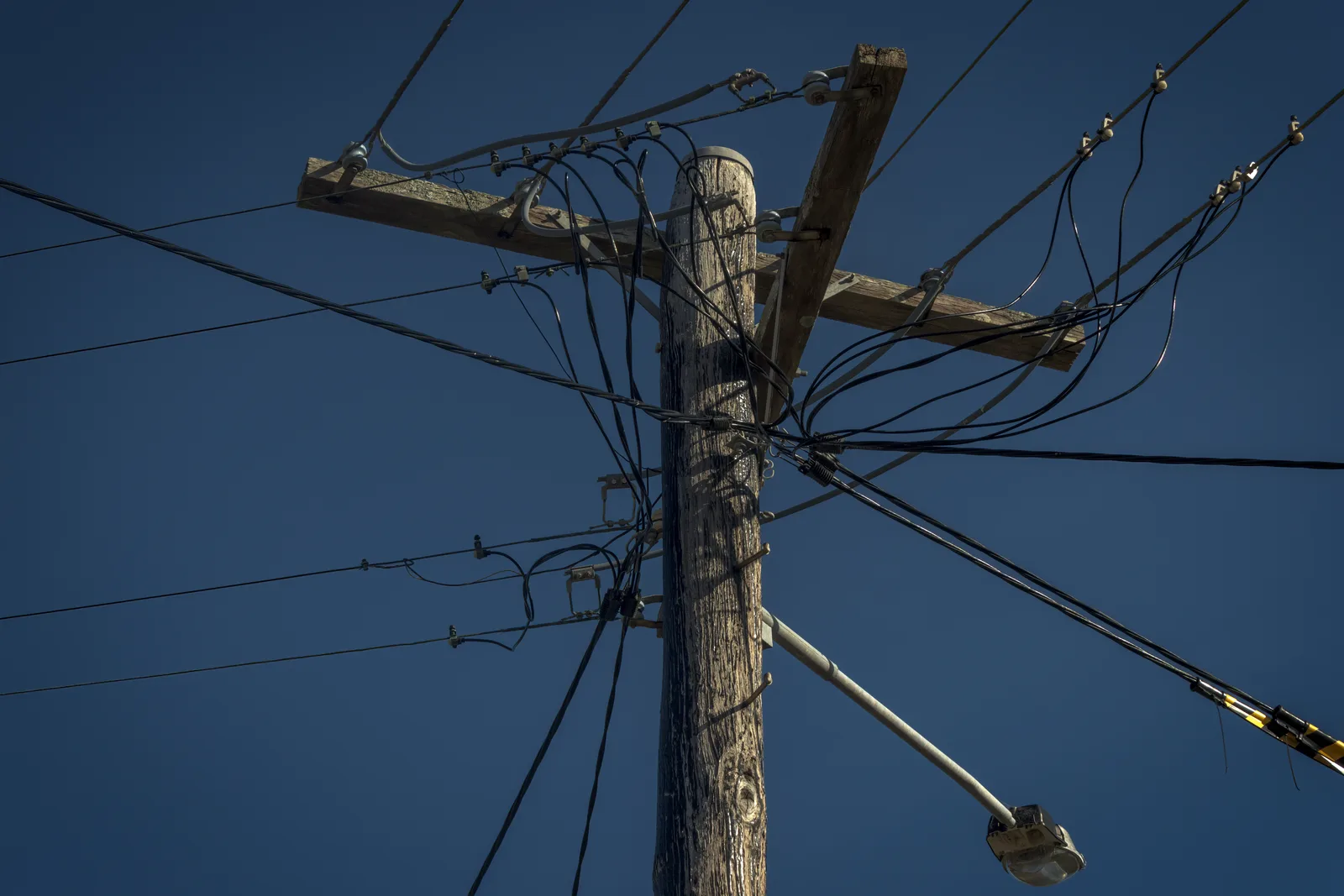 Overhead powerlines and service mains on a suburban pole
