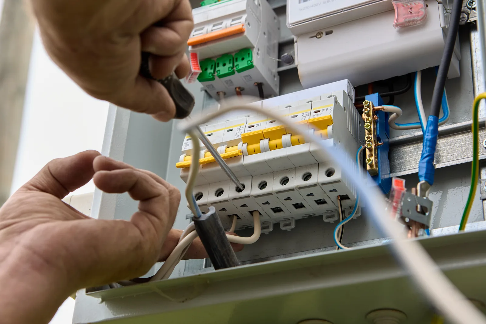 Electrician working through a switchboard repair